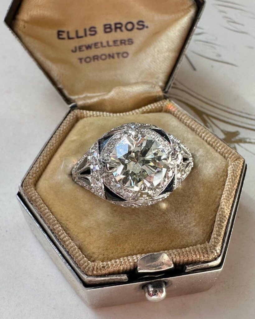 Antique diamond engagement ring in a vintage gold-lined jewelry box from Toronto